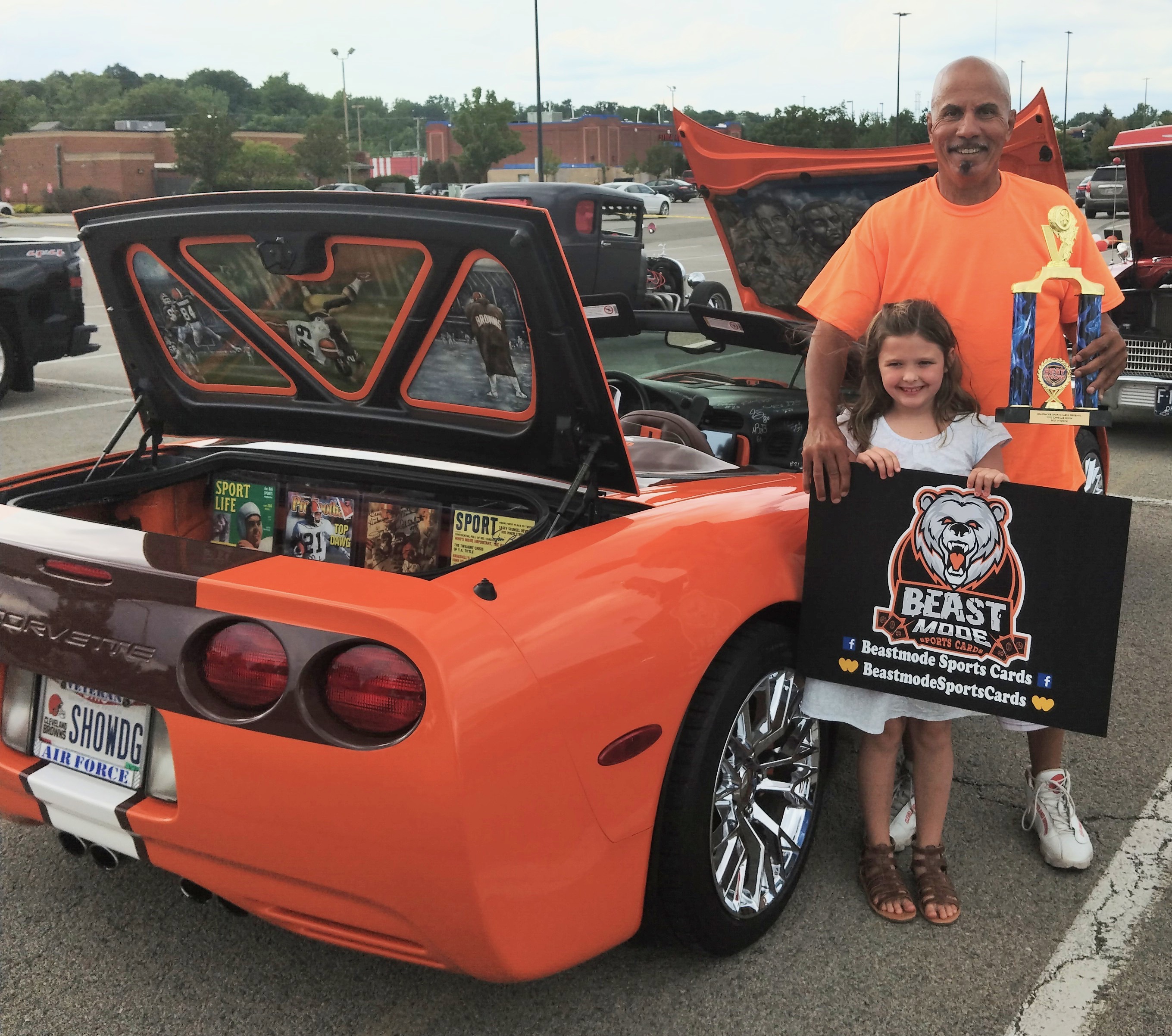 A trophy moment beside the Corvette