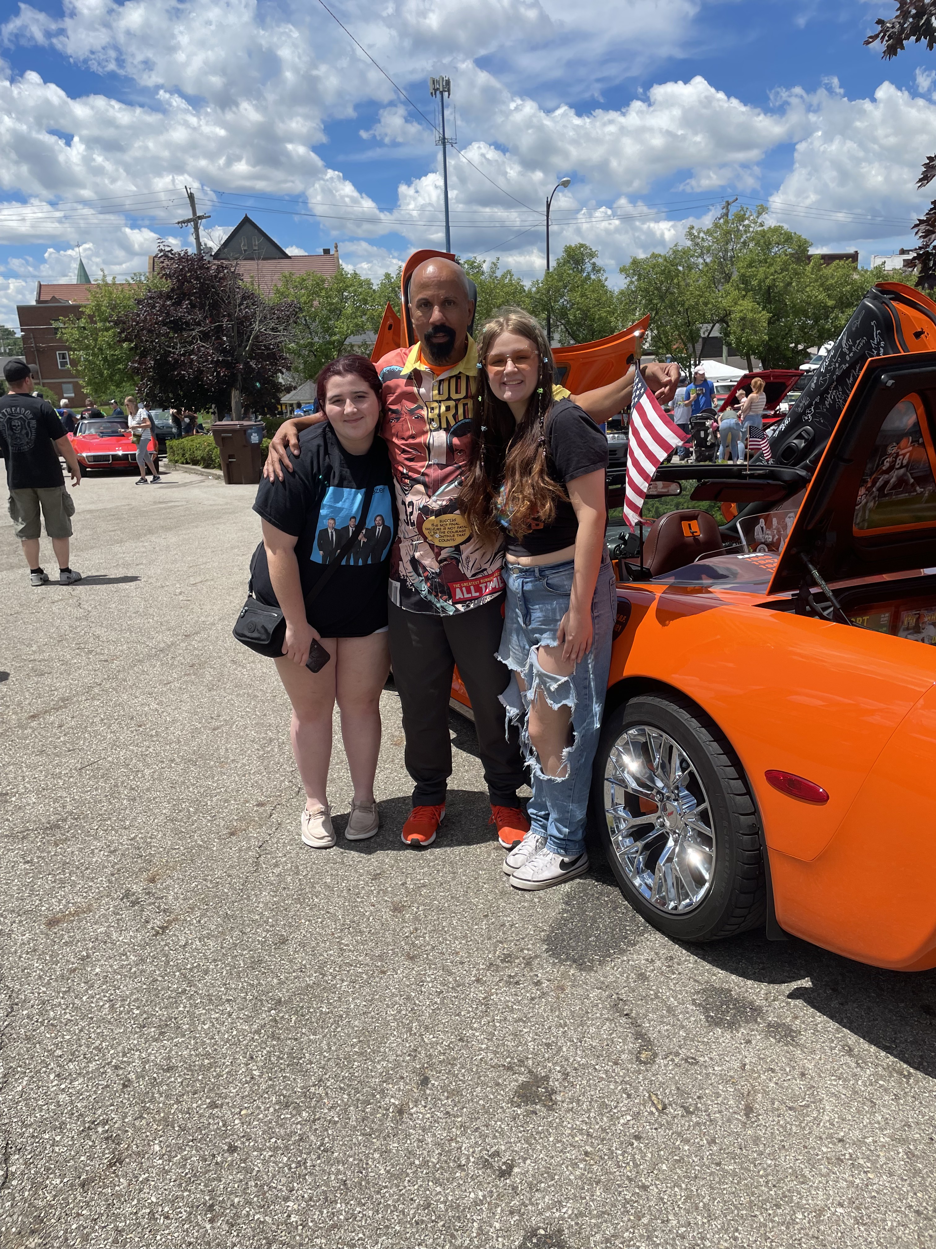 Summer-show guests beside the Corvette